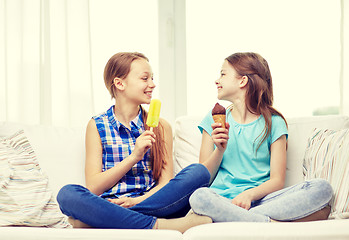 Image showing happy little girls eating ice-cream at home