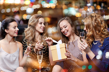 Image showing happy women with champagne and gift at night club