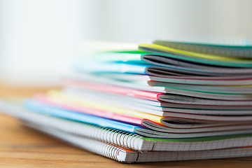 Image showing close up of notebooks on wooden table