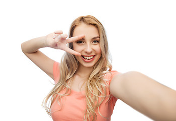 Image showing smiling woman taking selfie and showing peace sign