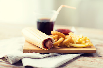 Image showing close up of fast food snacks and drink on table