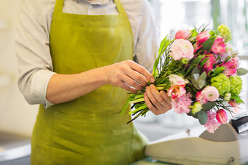 Image showing close up of man making bunch at flower shop