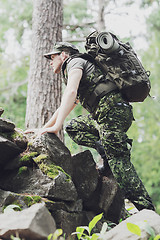 Image showing young soldier with backpack in forest