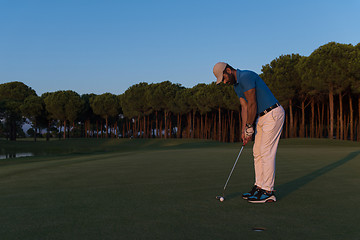 Image showing golfer  hitting shot at golf course