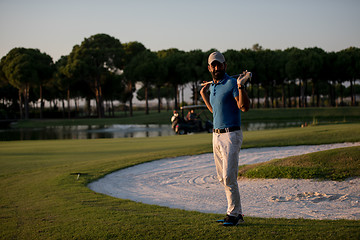 Image showing golfer  portrait at golf course on sunset