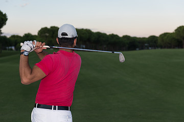 Image showing golfer hitting a sand bunker shot on sunset