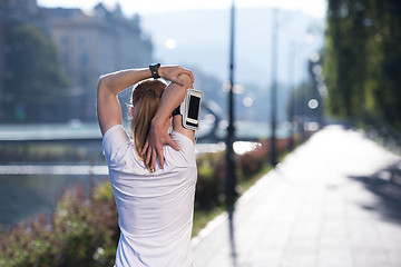 Image showing blonde woman  stretching before morning jogging