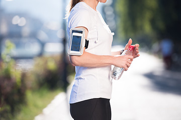 Image showing woman drinking  water after  jogging