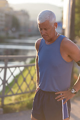 Image showing portrait of handsome senior jogging man