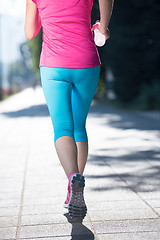 Image showing sporty woman running  on sidewalk