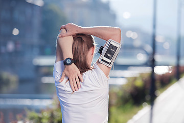 Image showing blonde woman  stretching before morning jogging