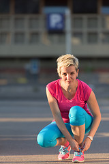 Image showing Closeup of woman tying running shoe