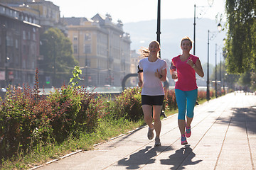 Image showing female friends jogging