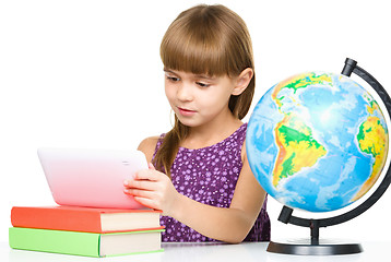 Image showing Young girl is using tablet