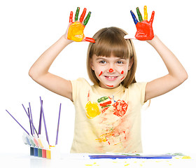 Image showing Portrait of a cute girl playing with paints