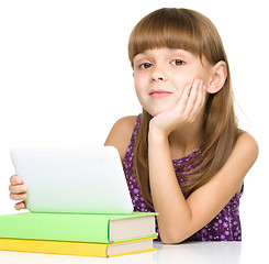 Image showing Young girl is using tablet