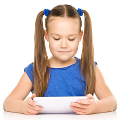 Image showing Young girl is using tablet