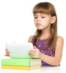 Image showing Young girl is using tablet