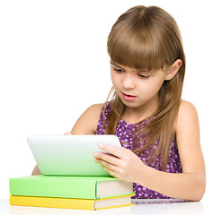 Image showing Young girl is using tablet