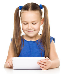 Image showing Young girl is using tablet