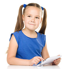 Image showing Young girl is using tablet