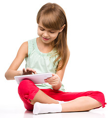 Image showing Young girl is using tablet