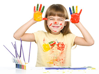 Image showing Portrait of a cute girl playing with paints