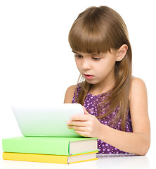 Image showing Young girl is using tablet