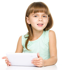 Image showing Young cheerful girl is using tablet