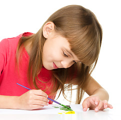 Image showing Little girl is painting with gouache