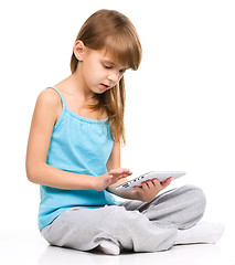 Image showing Young girl is using tablet