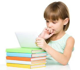 Image showing Young girl is using tablet while studying