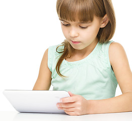 Image showing Young girl is using tablet