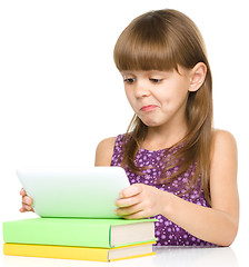 Image showing Young girl is using tablet