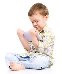 Image showing Young boy is using tablet