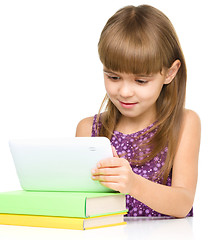 Image showing Young girl is using tablet