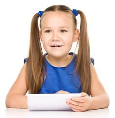 Image showing Young girl is using tablet