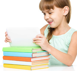 Image showing Young girl is using tablet