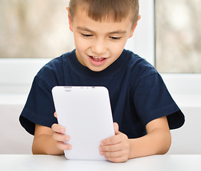 Image showing Young boy is using tablet