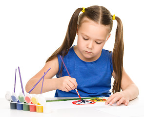 Image showing Little girl is painting with gouache