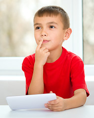 Image showing Young boy is using tablet