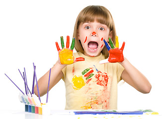 Image showing Portrait of a cute girl playing with paints