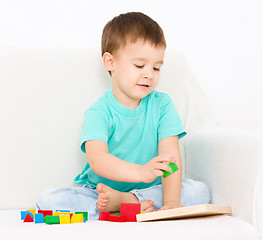 Image showing Boy is playing with puzzle