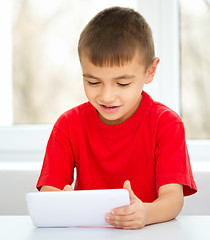 Image showing Young boy is using tablet