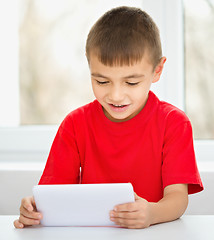 Image showing Young boy is using tablet