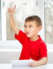 Image showing Young boy is using tablet