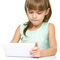 Image showing Young girl is using tablet