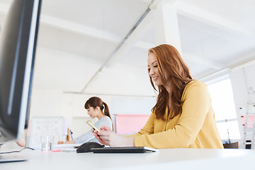 Image showing businesswoman texting on smartphone at office