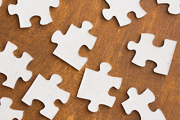 Image showing close up of puzzle pieces on wooden surface