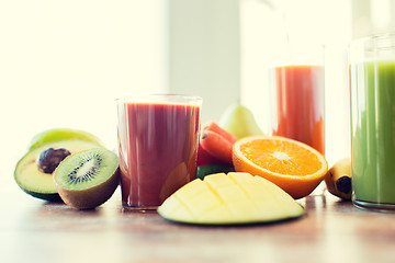 Image showing close up of fresh juice glass and fruits on table